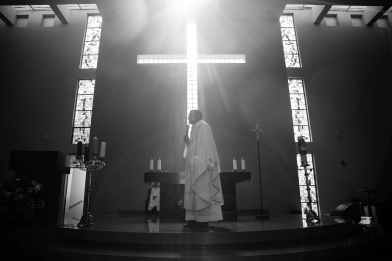 priest standing on a podium during mass